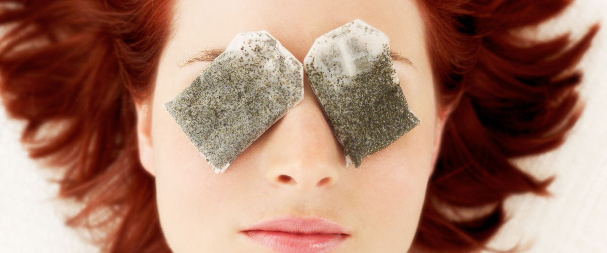 woman with chamomile teabags on her eyes