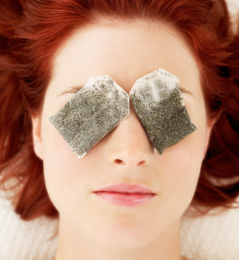 woman with chamomile teabags on her eyes