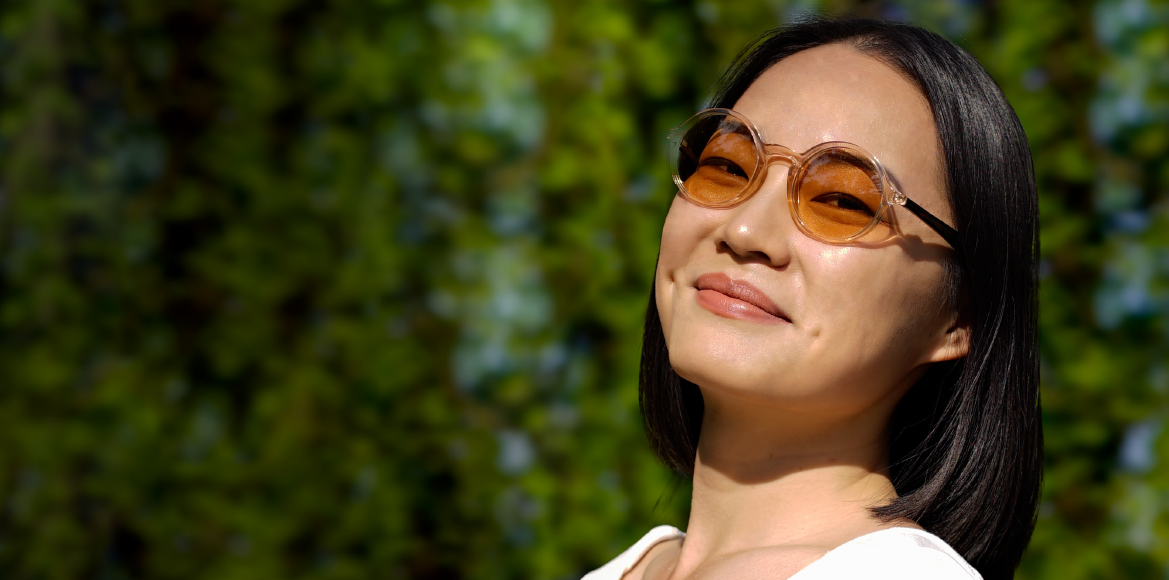 woman wearing tinted lenses sunglasses and smiling