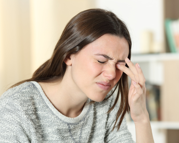 woman rubbing her eye