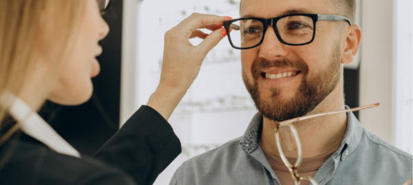 Man changing glasses to improve vision