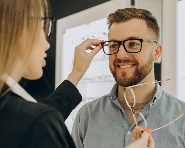 Man changing glasses to improve vision