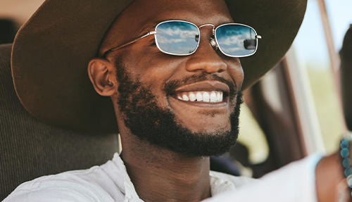 man driving wearing sunglasses with mirrored lenses