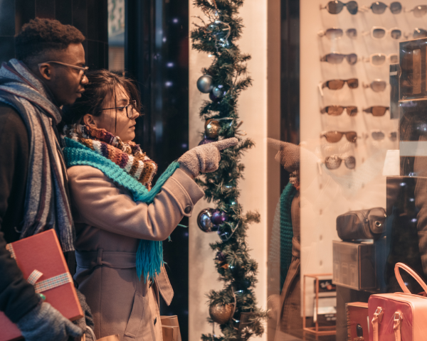 man and women couple christmas shopping for glasses
