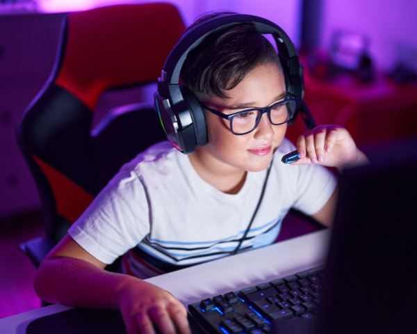 kid wearing glasses while playing computer games