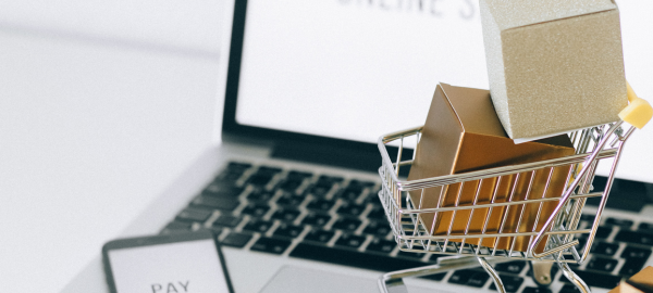 laptop with small cart and smartphone on the side