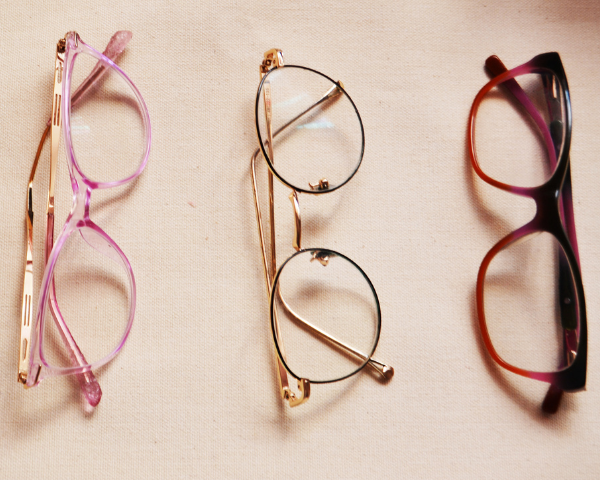 three glasses on pink background side by side
