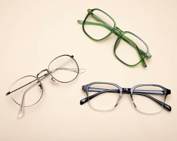 three pairs of eyeglasses on a table