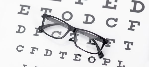 glasses resting on eye chart