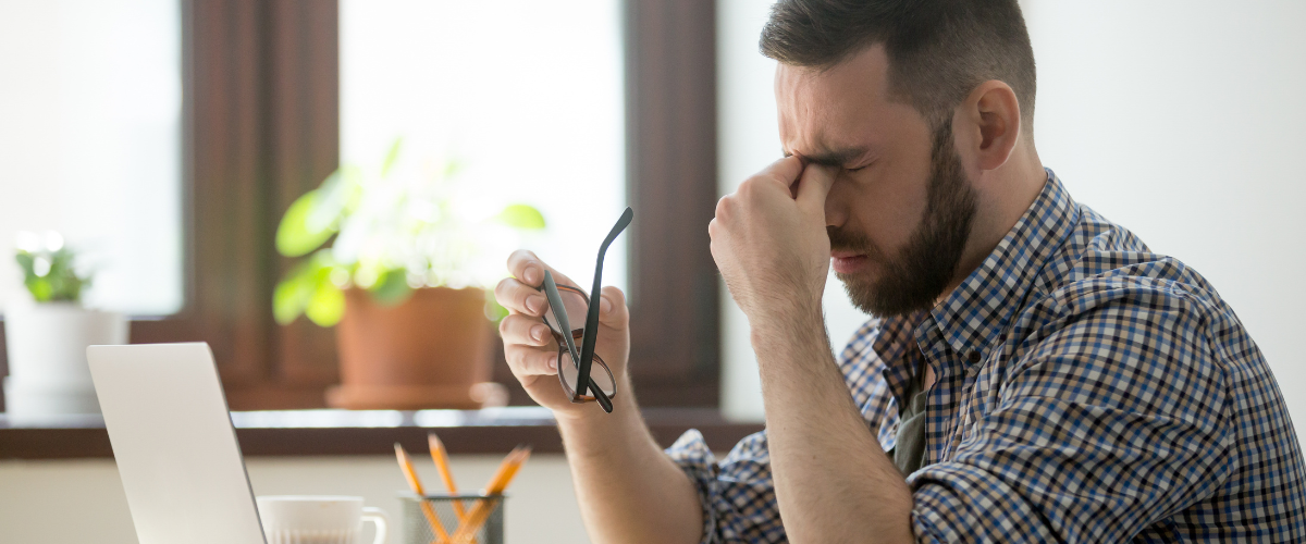 man suffering from digital eye strain