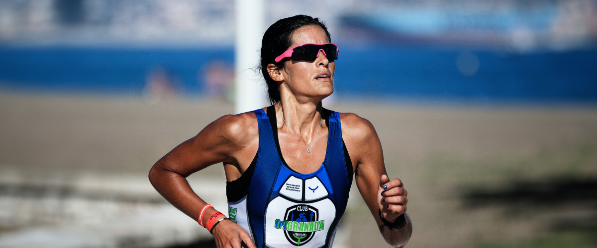 woman running wearing sports sunglasses