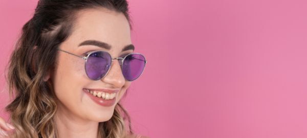brunette girl wearing purple-tinted sunglasses