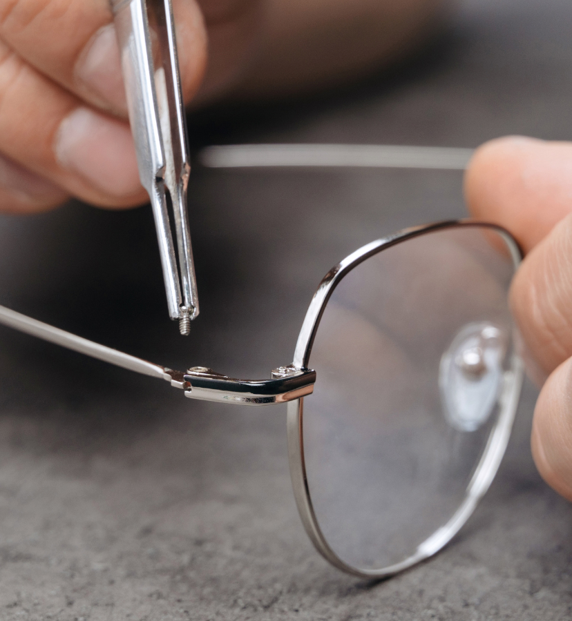 person adjusting glasses frame
