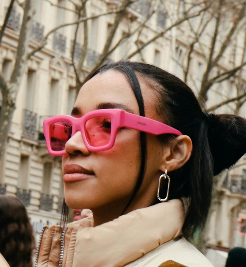 a woman wearing bright pink sunglasses