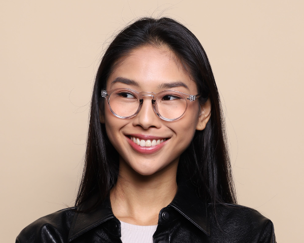 woman wearing clear frame glasses smiling