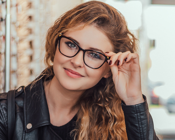 model wearing glasses and smiling