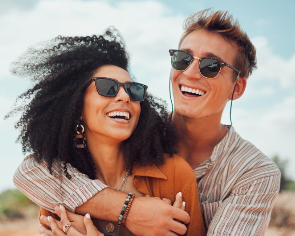 man and woman wearing polarised sunglasses outside