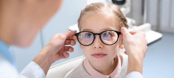 young girl being fitted for prescription glasses