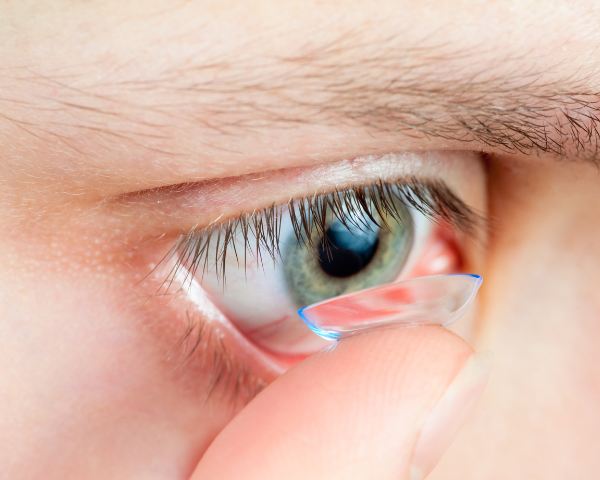Contact lense being applied up close